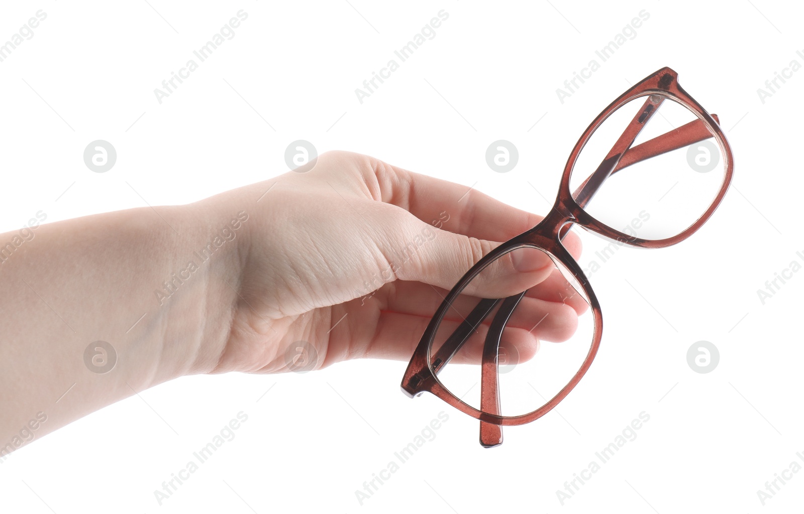 Photo of Woman holding glasses with brown frame on white background, closeup