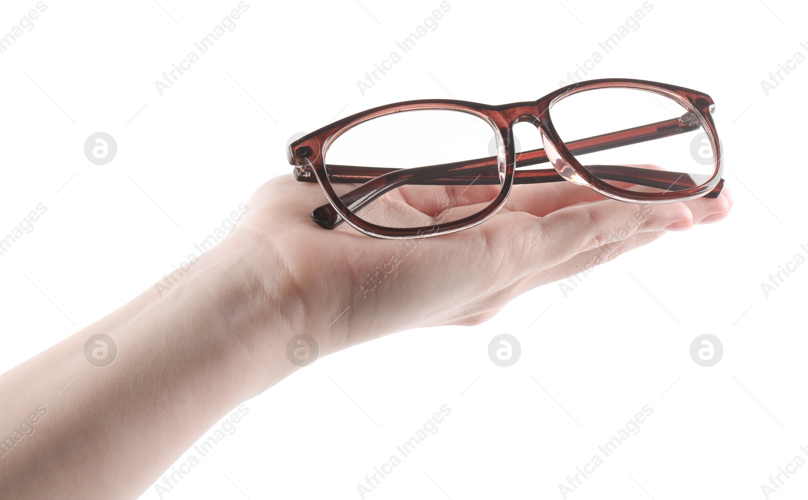 Woman holding glasses with brown frame on white background, closeup Photo of Woman holding glasses with brown frame on white background, closeup