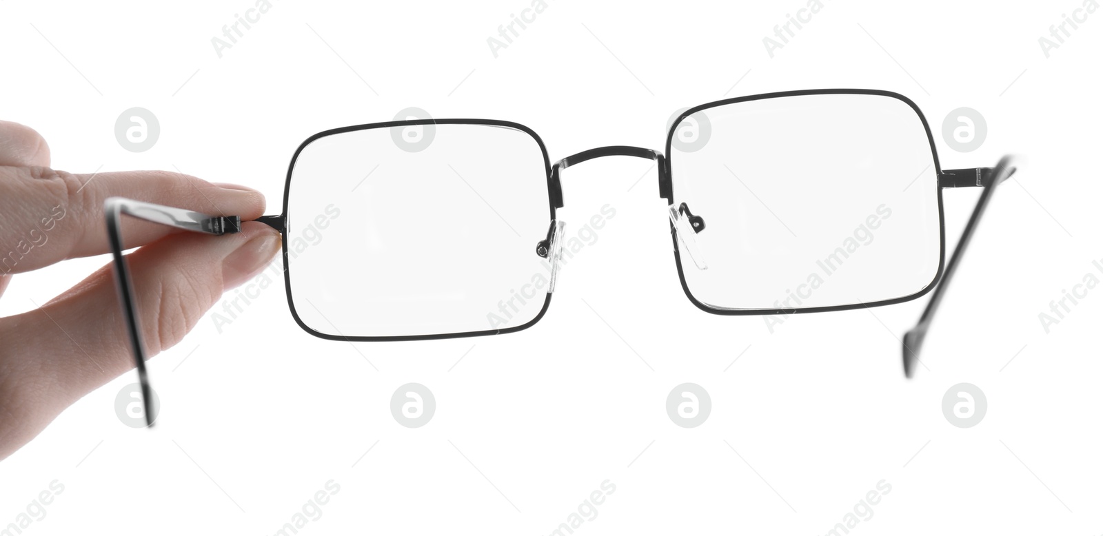 Photo of Woman holding glasses with black metal frame on white background, closeup