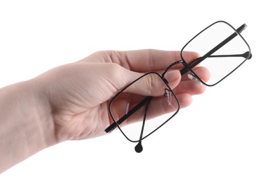 Photo of Woman holding glasses with black metal frame on white background, closeup