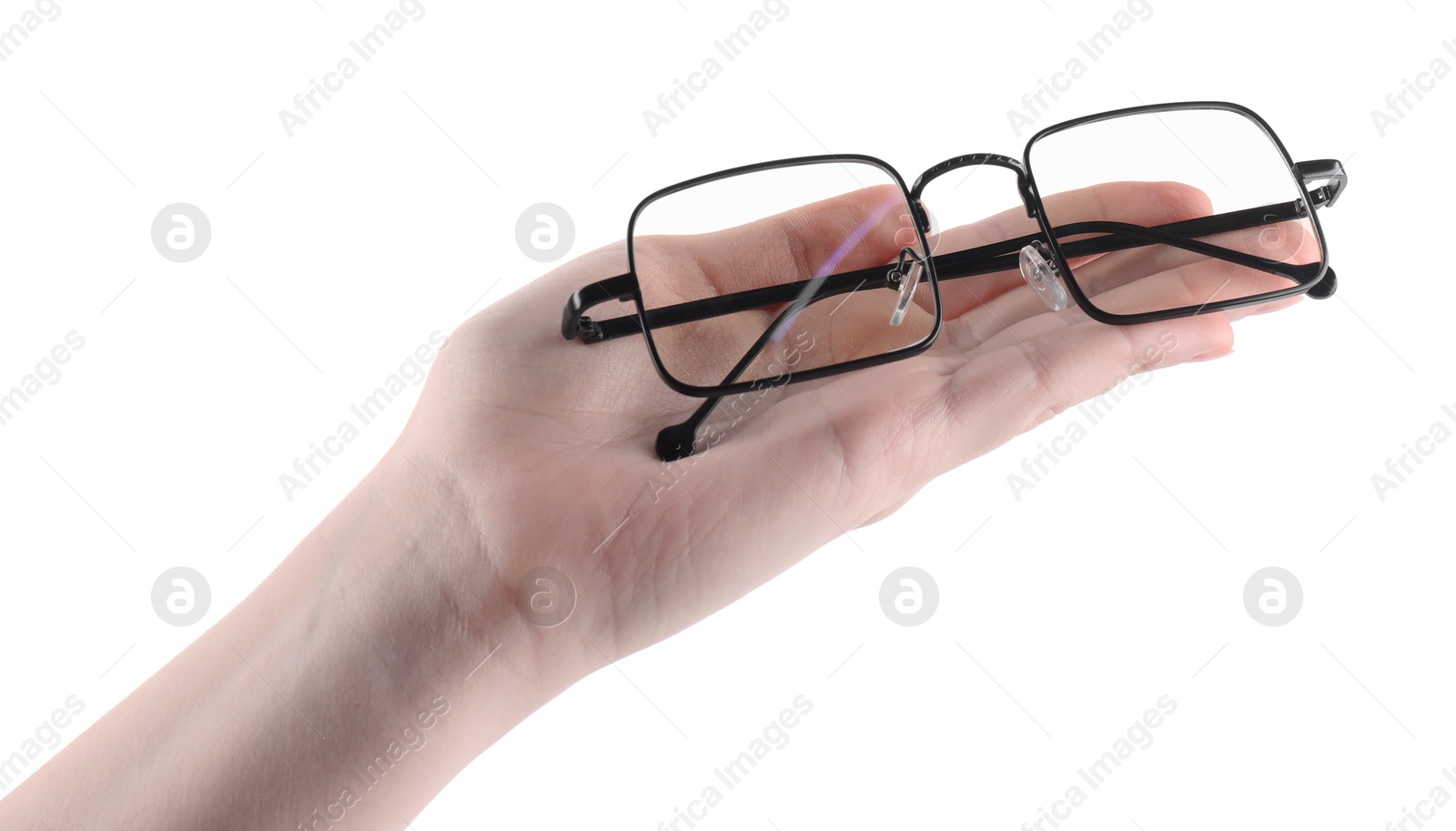 Photo of Woman holding glasses with black metal frame on white background, closeup