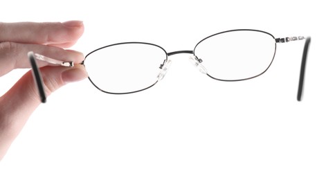 Photo of Woman holding glasses with round metal frame on white background, closeup