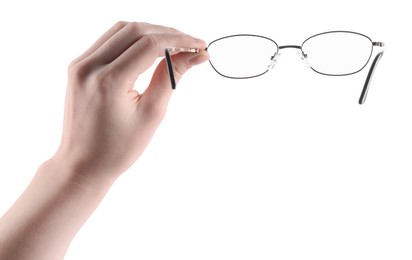 Photo of Woman holding glasses with round metal frame on white background, closeup