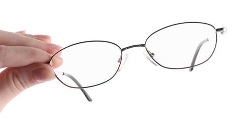 Photo of Woman holding glasses with round metal frame on white background, closeup