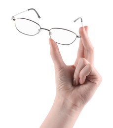 Photo of Woman holding glasses with round metal frame on white background, closeup