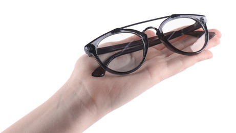 Photo of Woman holding glasses with stylish frame on white background, closeup