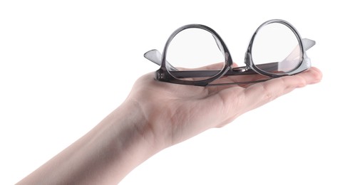 Photo of Woman holding glasses with stylish frame on white background, closeup