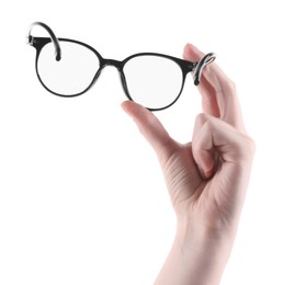 Photo of Woman holding glasses with trendy black frame on white background, closeup