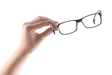 Photo of Woman holding glasses with black plastic frame on white background, closeup