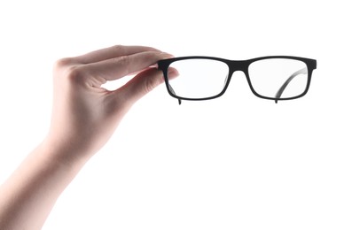 Photo of Woman holding glasses with black plastic frame on white background, closeup