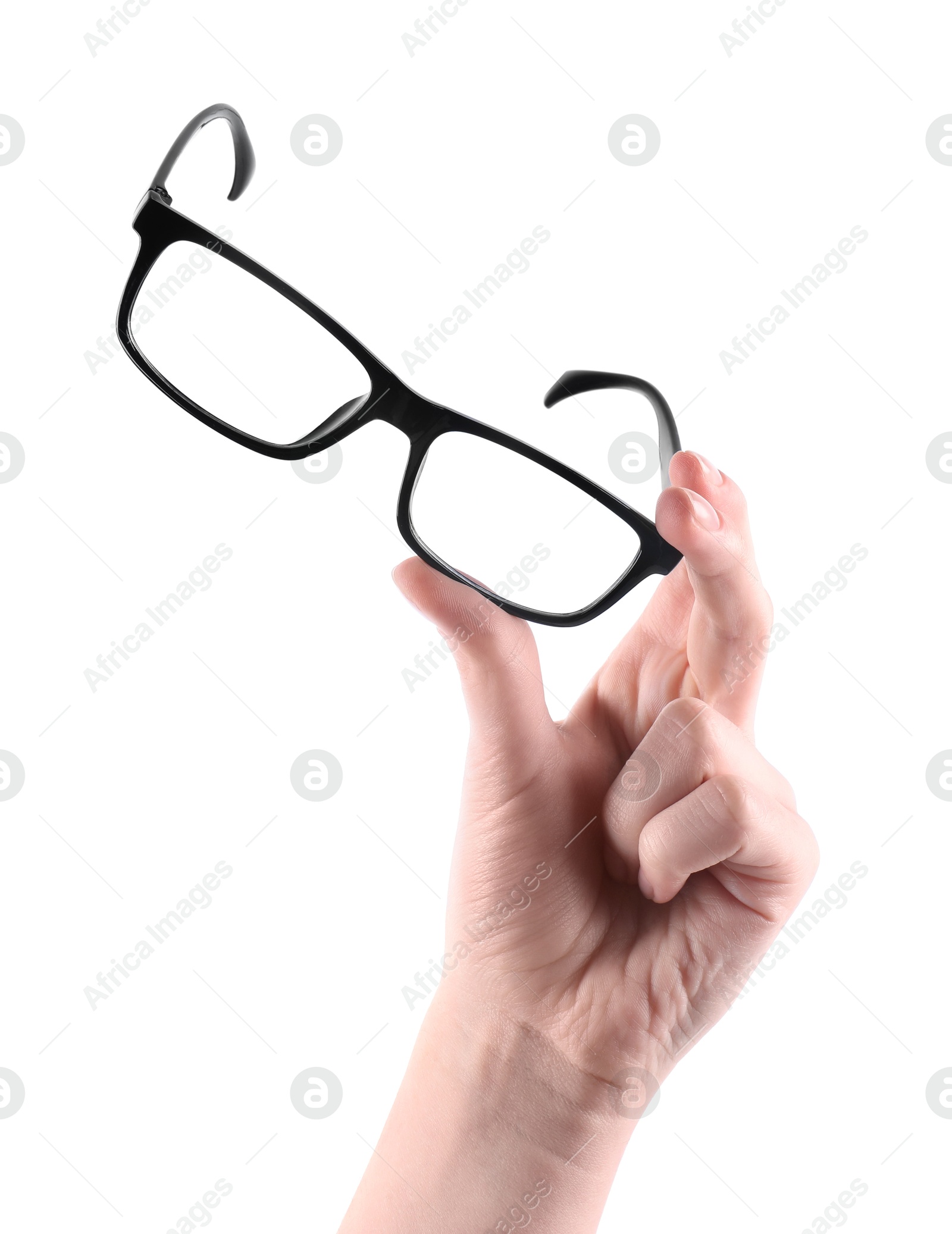 Photo of Woman holding glasses with black plastic frame on white background, closeup