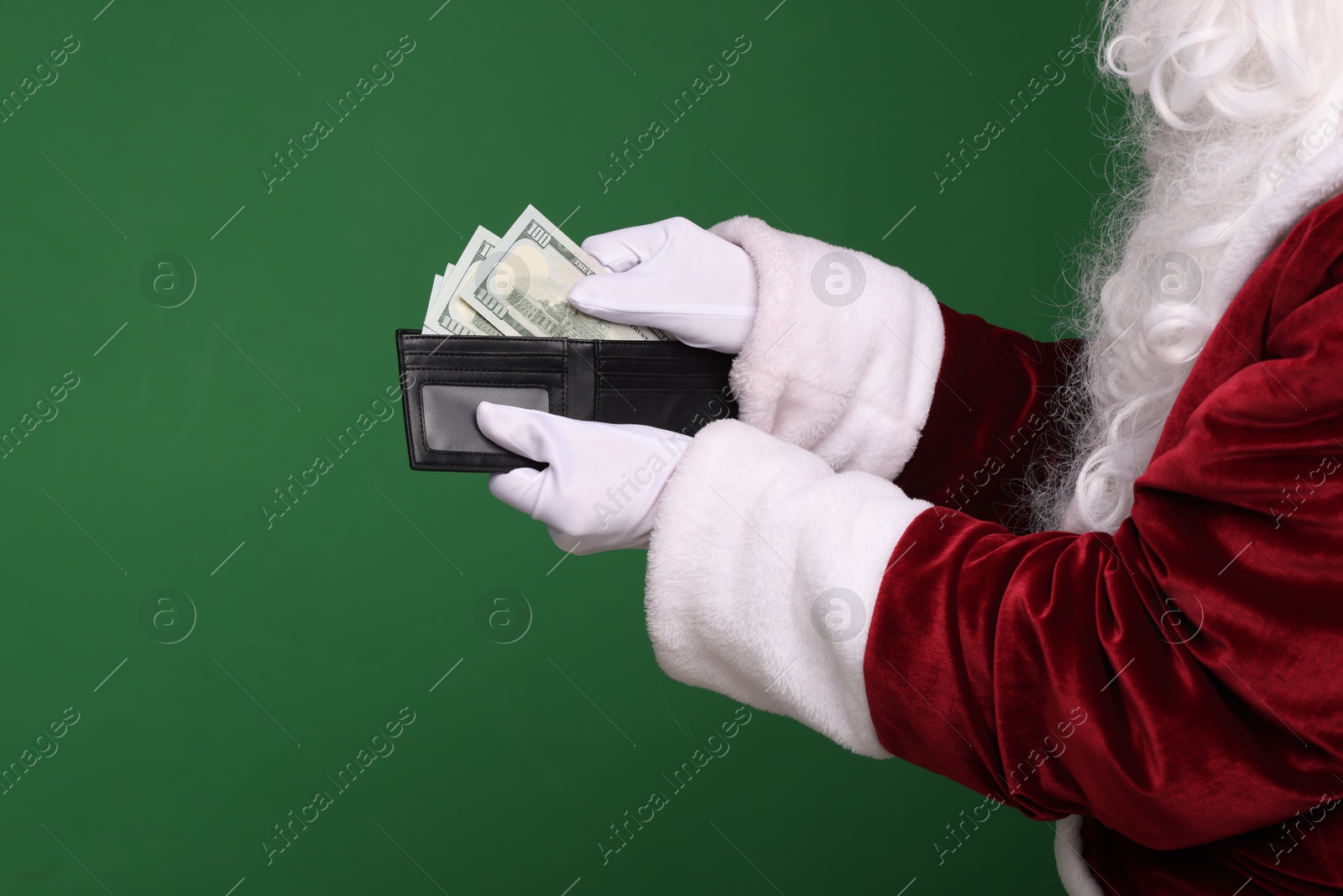 Photo of Santa Claus with dollar banknotes on green background, closeup. Space for text