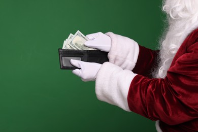 Santa Claus with dollar banknotes on green background, closeup. Space for text