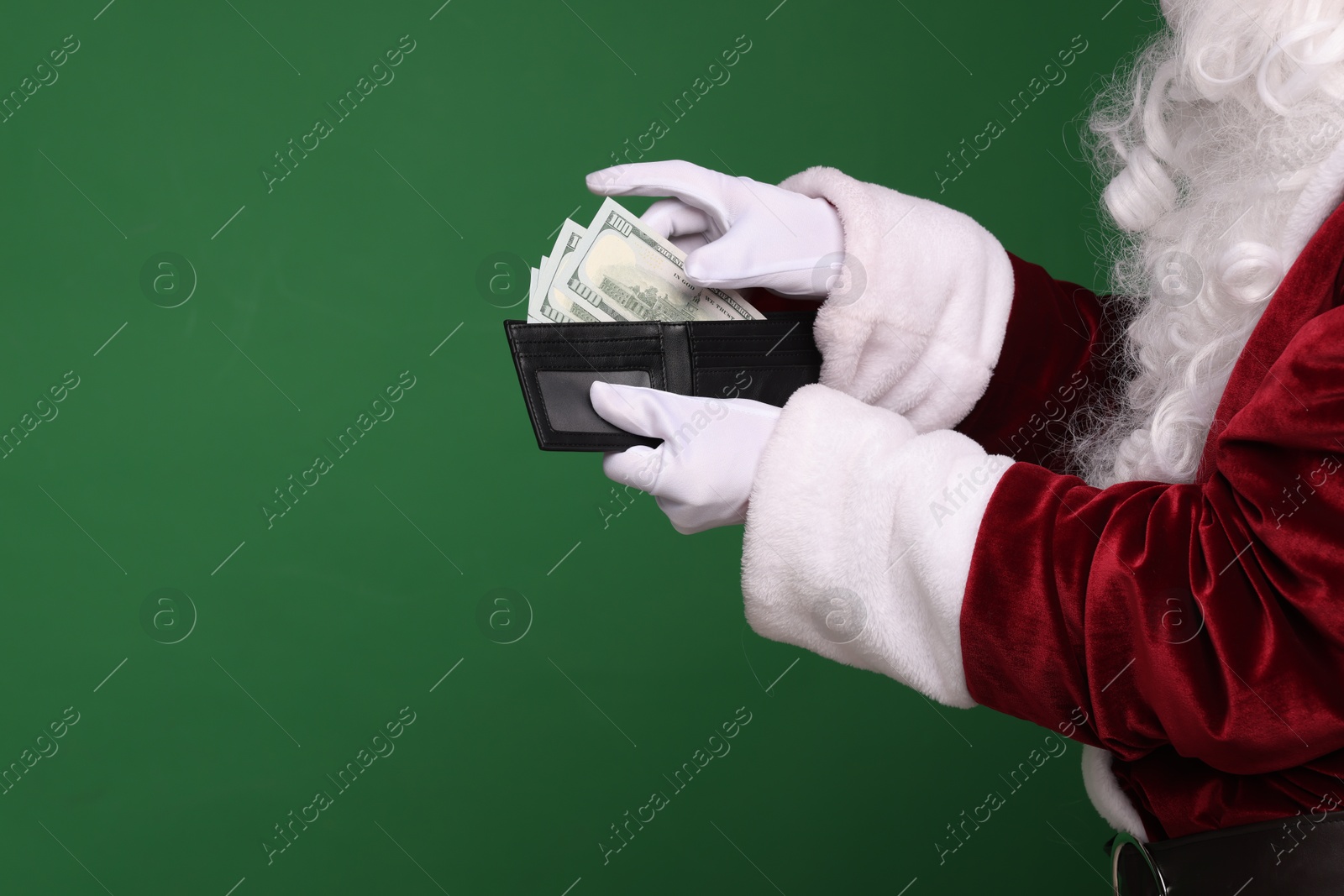 Photo of Santa Claus with dollar banknotes on green background, closeup. Space for text