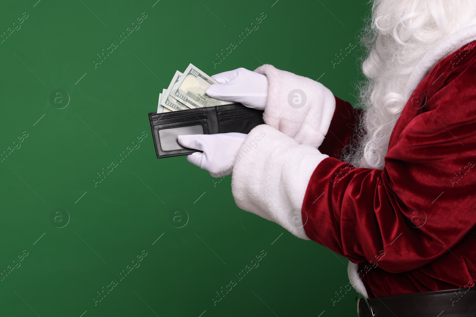 Photo of Santa Claus with dollar banknotes on green background, closeup. Space for text