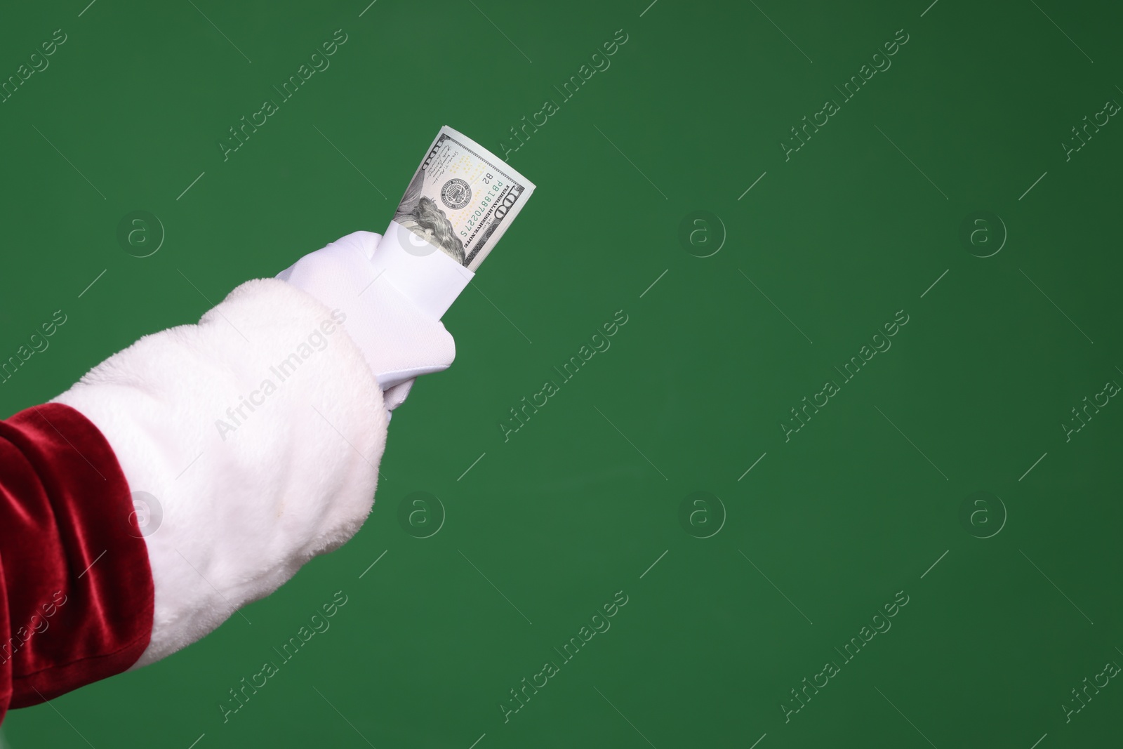 Photo of Santa Claus with dollar banknotes on green background, closeup. Space for text