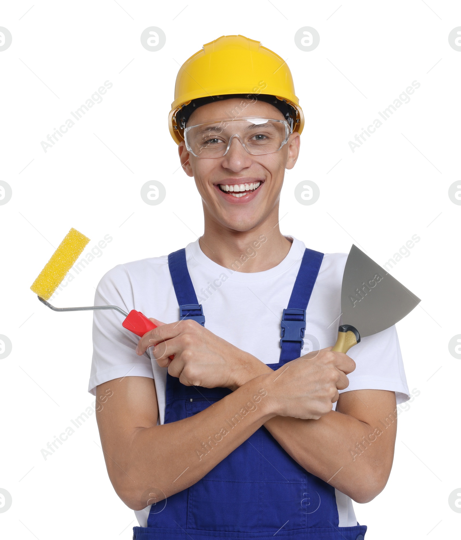 Photo of Portrait of young decorator with paint roller and putty knife on white background