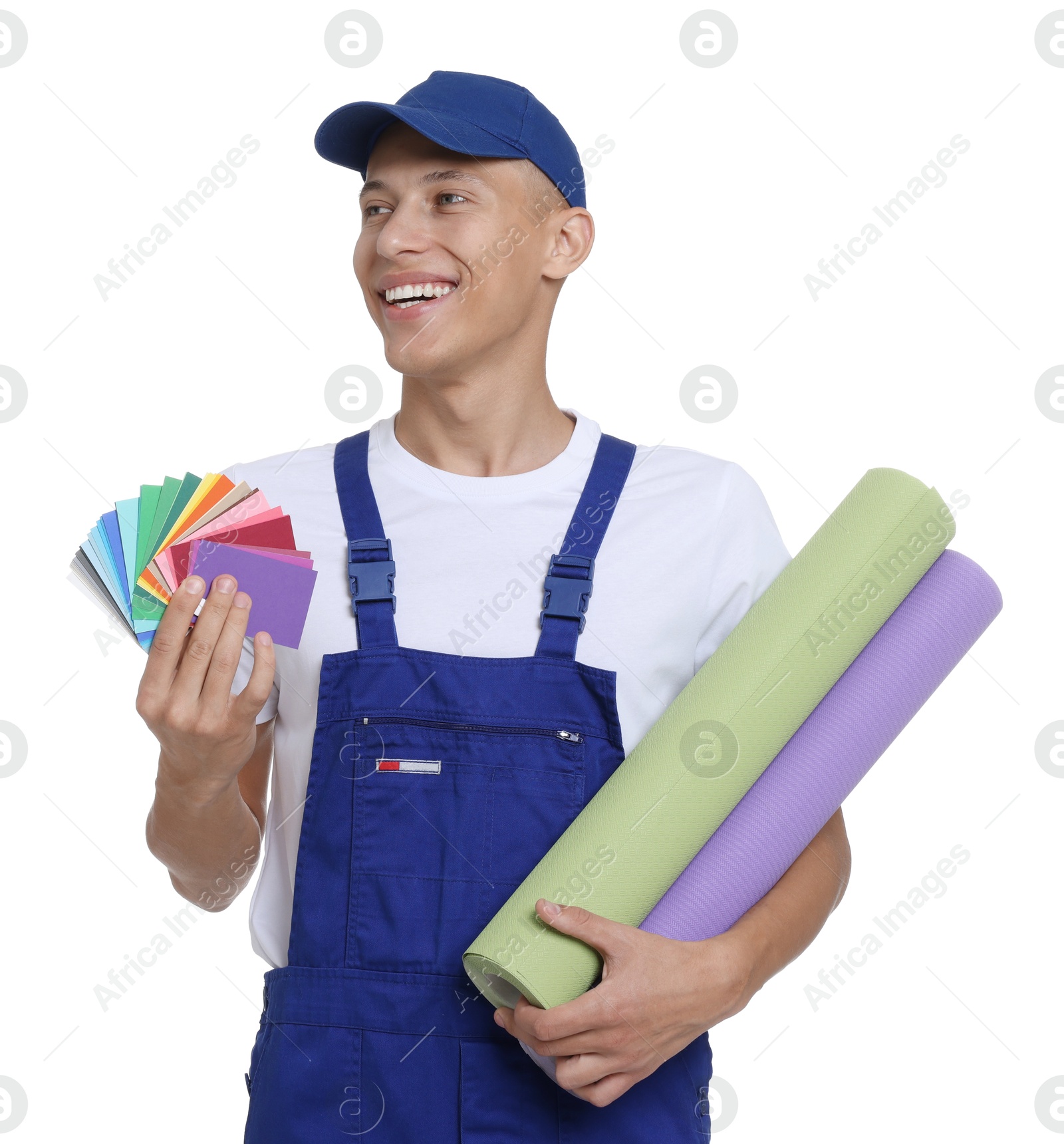 Photo of Young decorator with color palettes and rolls of wallpaper on white background