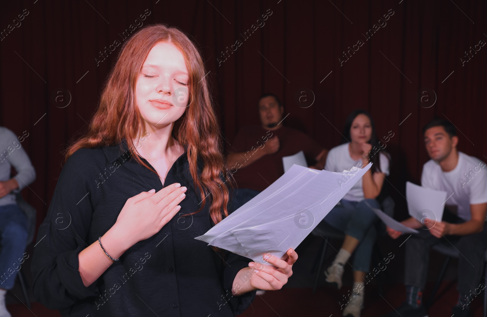 Photo of Professional actress rehearsing on stage in theatre