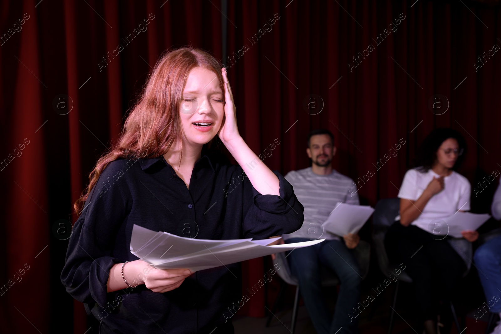 Photo of Professional actress rehearsing on stage in theatre