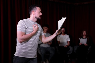 Photo of Professional actor rehearsing on stage in theatre