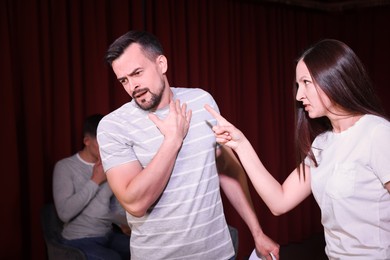 Professional actors rehearsing on stage in theatre