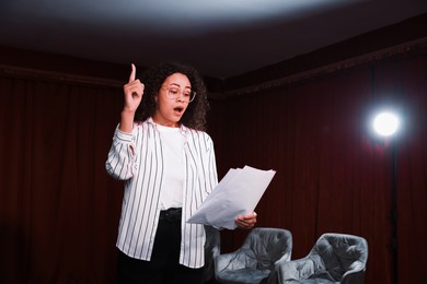 Photo of Professional actress rehearsing on stage in theatre