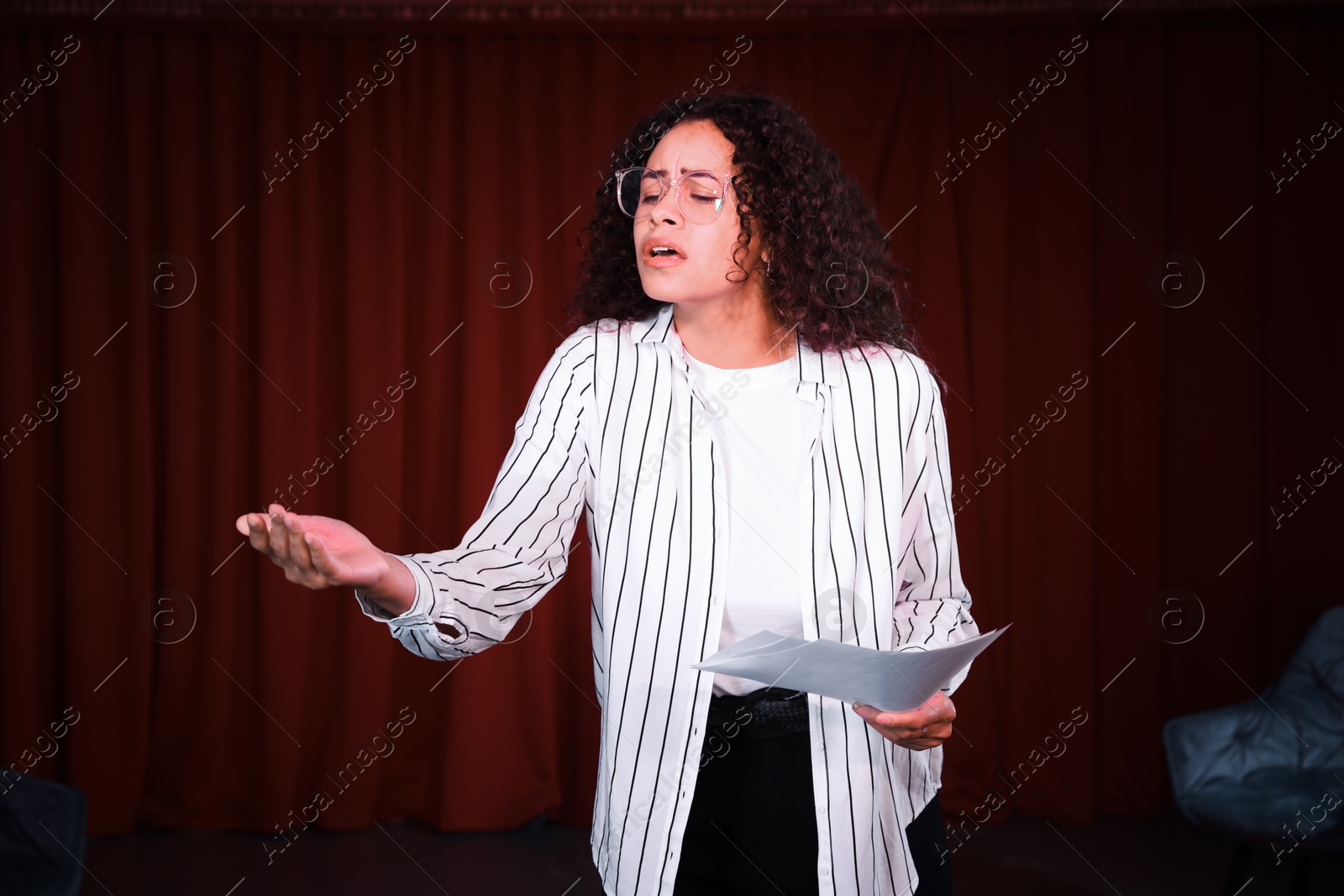 Photo of Professional actress rehearsing on stage in theatre