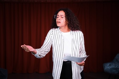 Photo of Professional actress rehearsing on stage in theatre