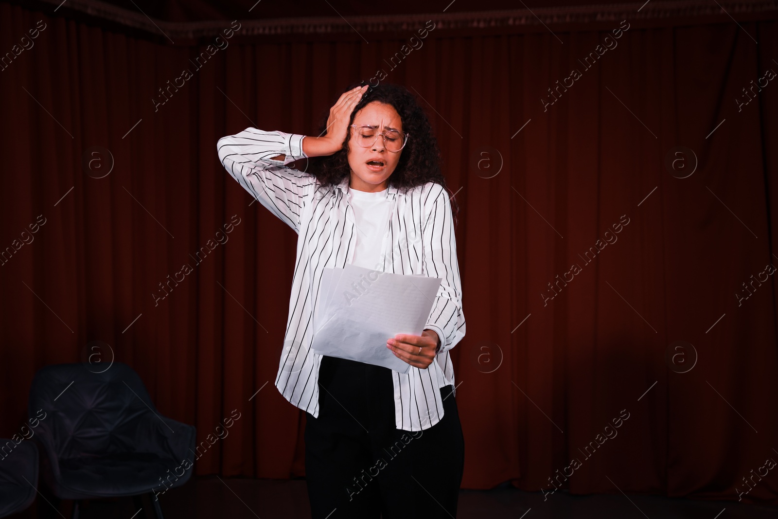 Photo of Professional actress rehearsing on stage in theatre