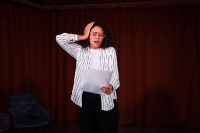 Photo of Professional actress rehearsing on stage in theatre