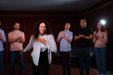 Photo of Professional actors bowing on stage in theatre