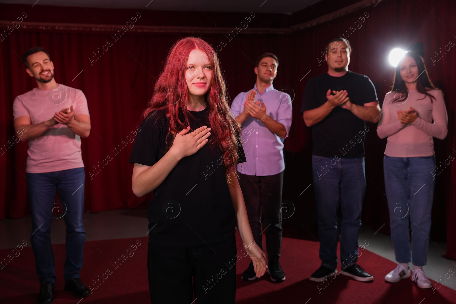 Photo of Professional actors bowing on stage in theatre