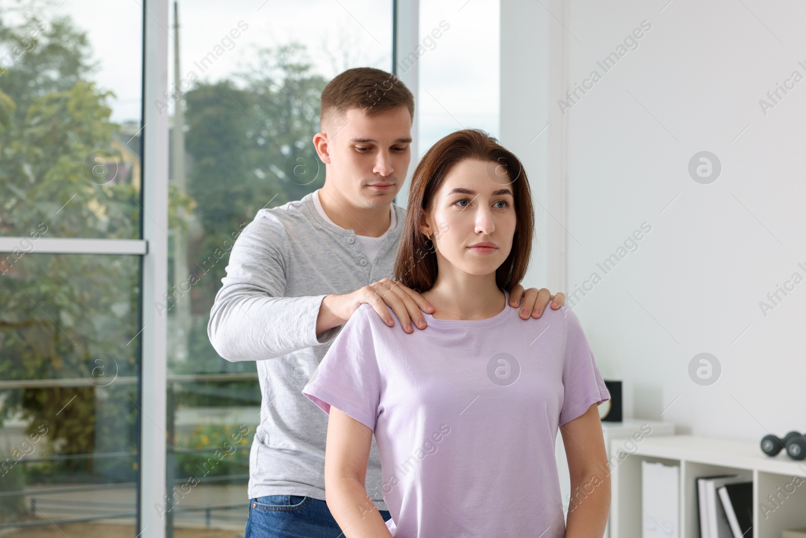 Photo of Osteopath working with patient in clinic. Manual therapy