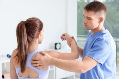 Photo of Osteopath working with patient in clinic. Manual therapy