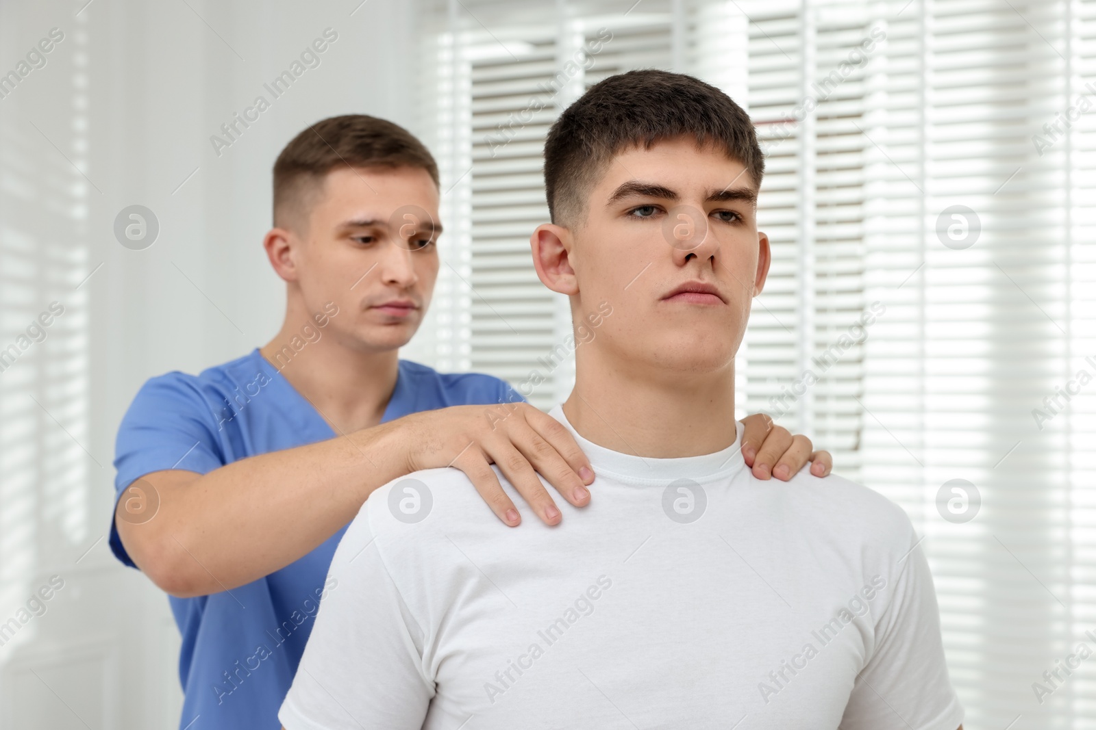 Photo of Osteopath working with patient in clinic. Manual therapy