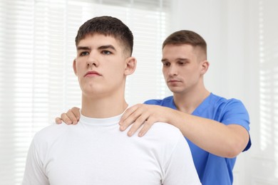 Photo of Osteopath working with patient in clinic. Manual therapy