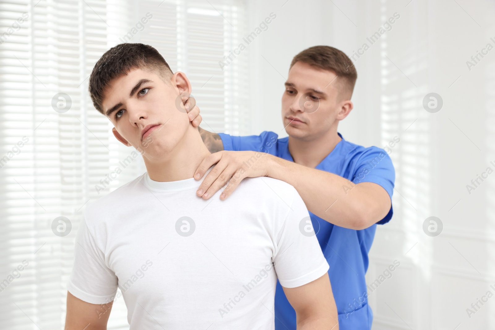 Photo of Osteopath working with patient in clinic. Manual therapy