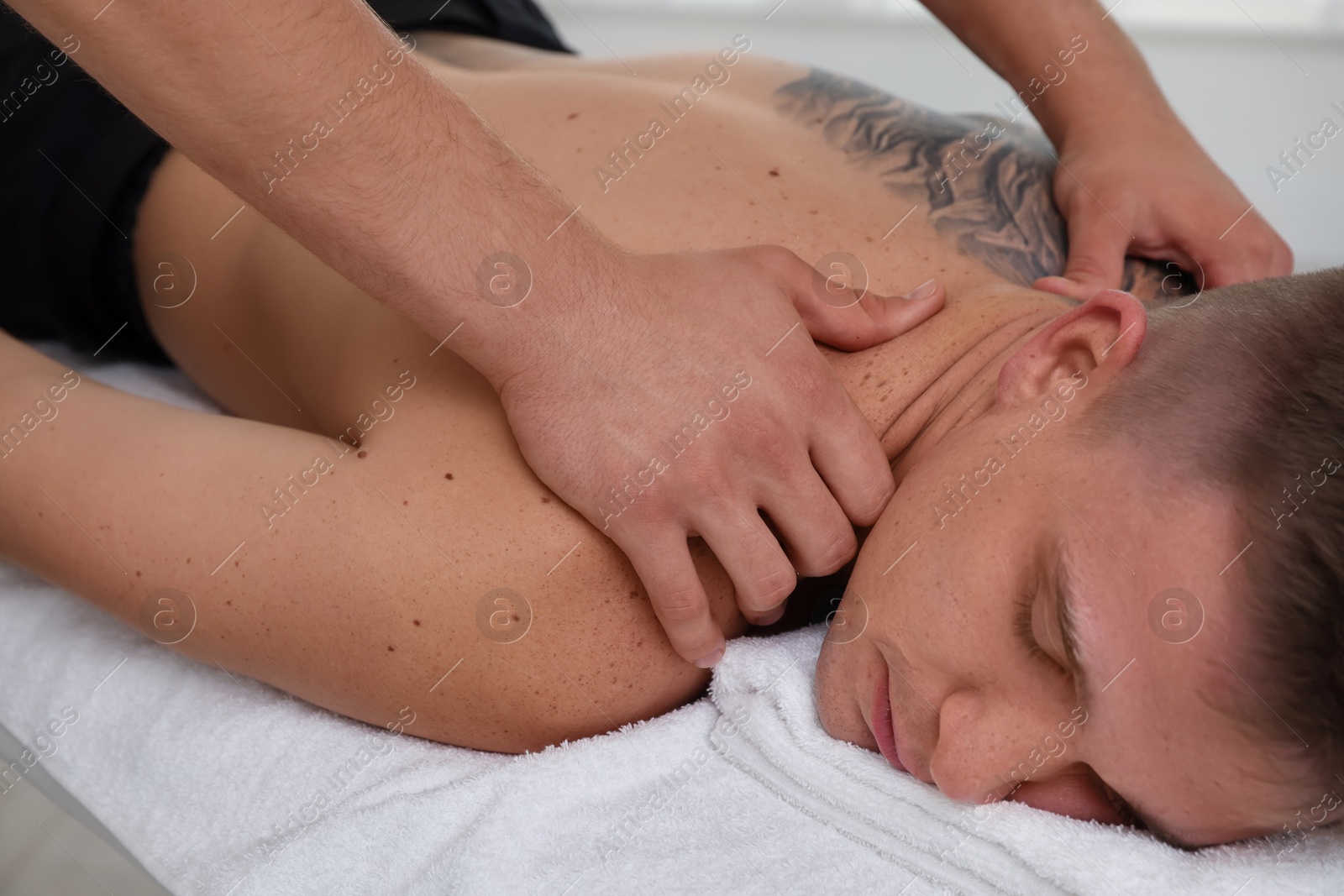 Photo of Massage therapist working with patient in clinic, closeup