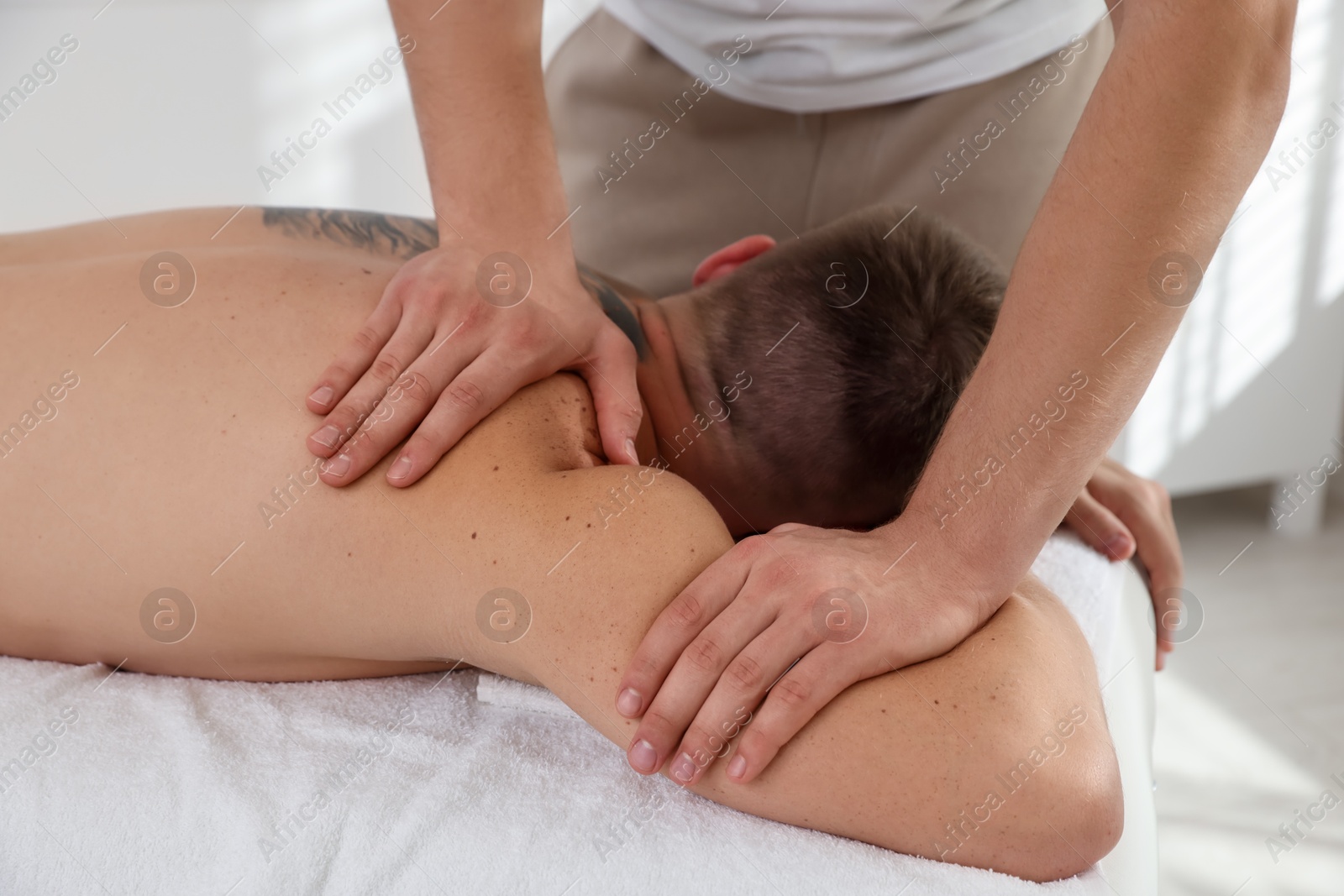 Photo of Massage therapist working with patient in clinic, closeup