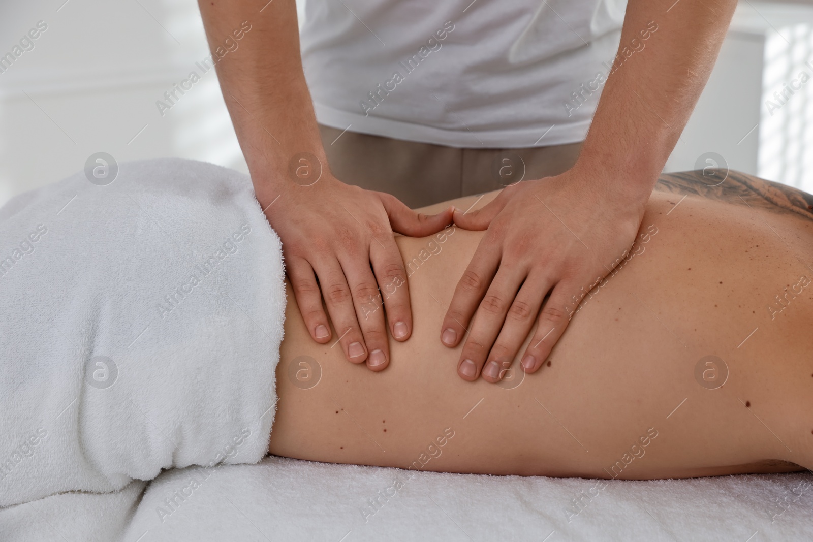 Photo of Massage therapist working with patient in clinic, closeup