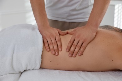 Photo of Massage therapist working with patient in clinic, closeup