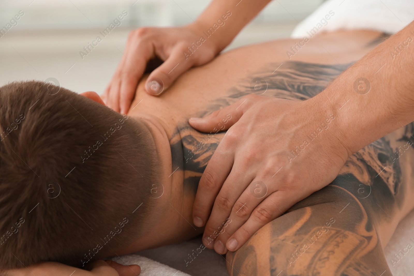 Photo of Massage therapist working with patient in clinic, closeup