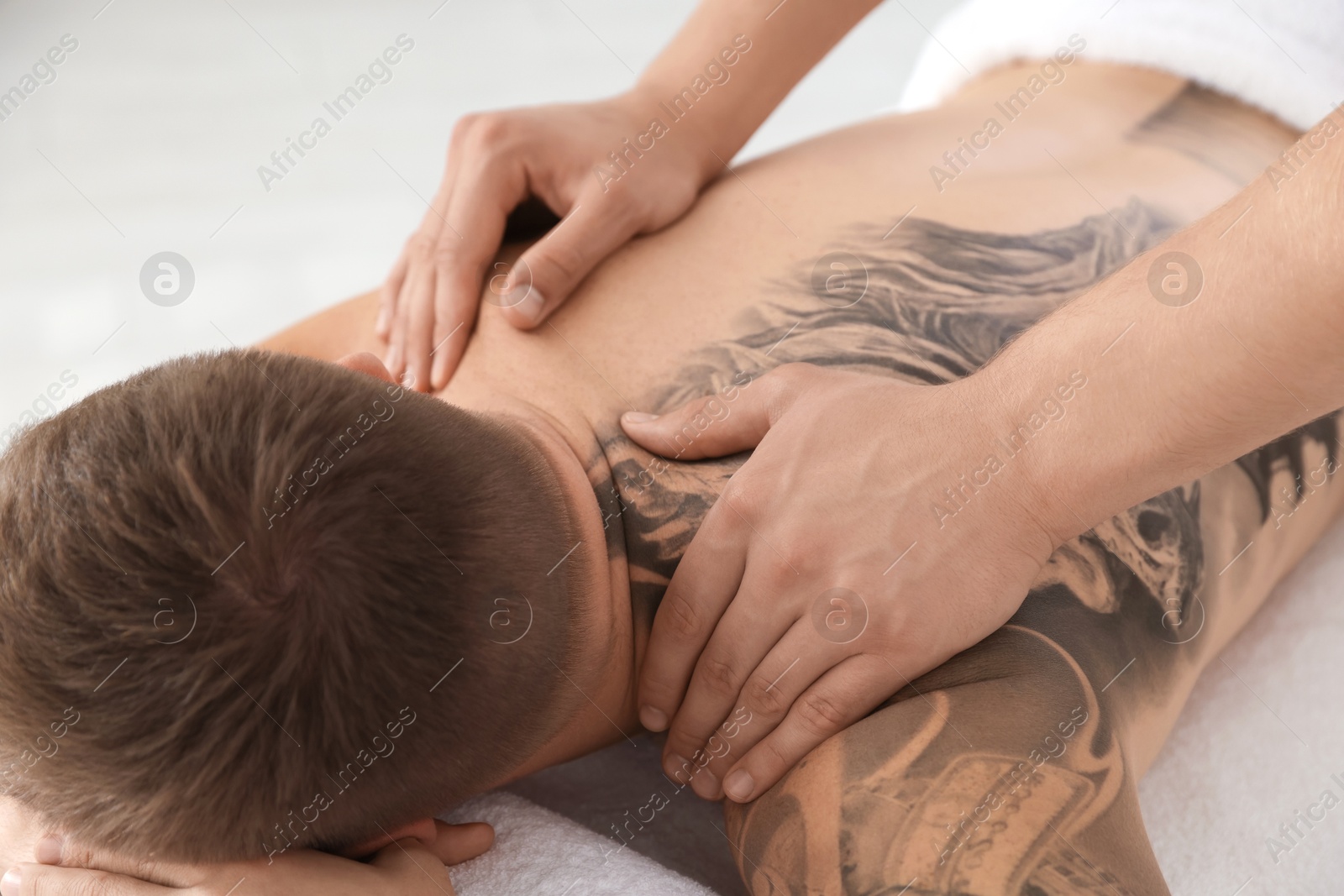 Photo of Massage therapist working with patient in clinic, closeup