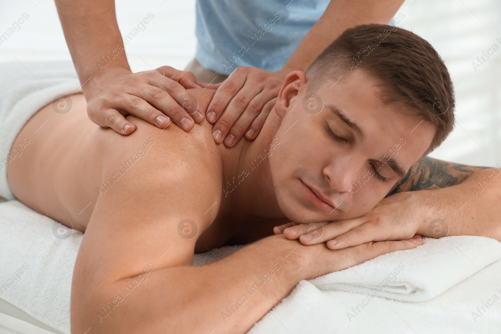 Photo of Massage therapist working with patient in clinic, closeup