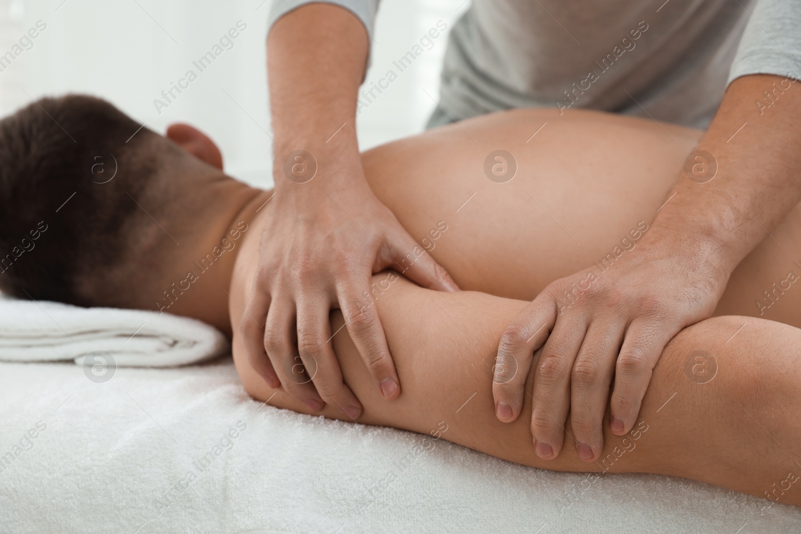 Photo of Massage therapist working with patient in clinic, closeup