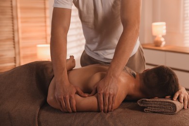 Photo of Massage therapist working with patient in clinic, closeup