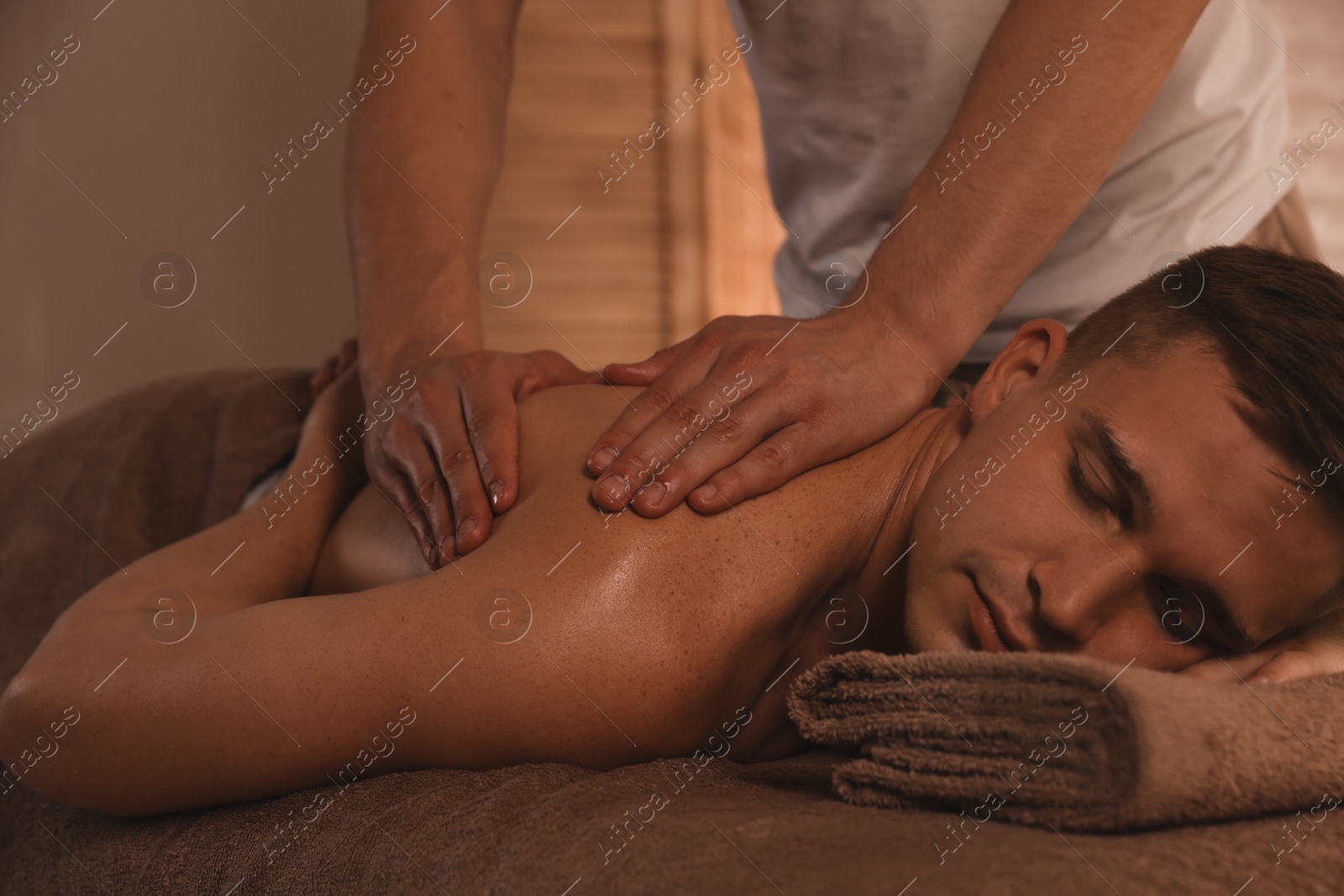 Photo of Massage therapist working with patient in clinic, closeup