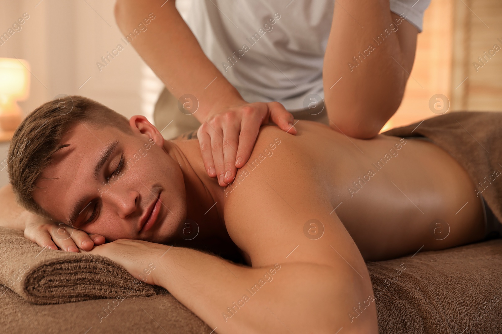 Photo of Massage therapist working with patient in clinic, closeup