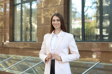 Photo of Portrait of young woman wearing stylish suit outdoors